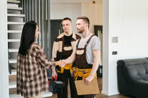 A group of people discussing plumbing troubles in living-room