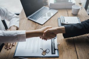 Agent and customer shake hands when successful trading houses. House and real estate trading ideas.